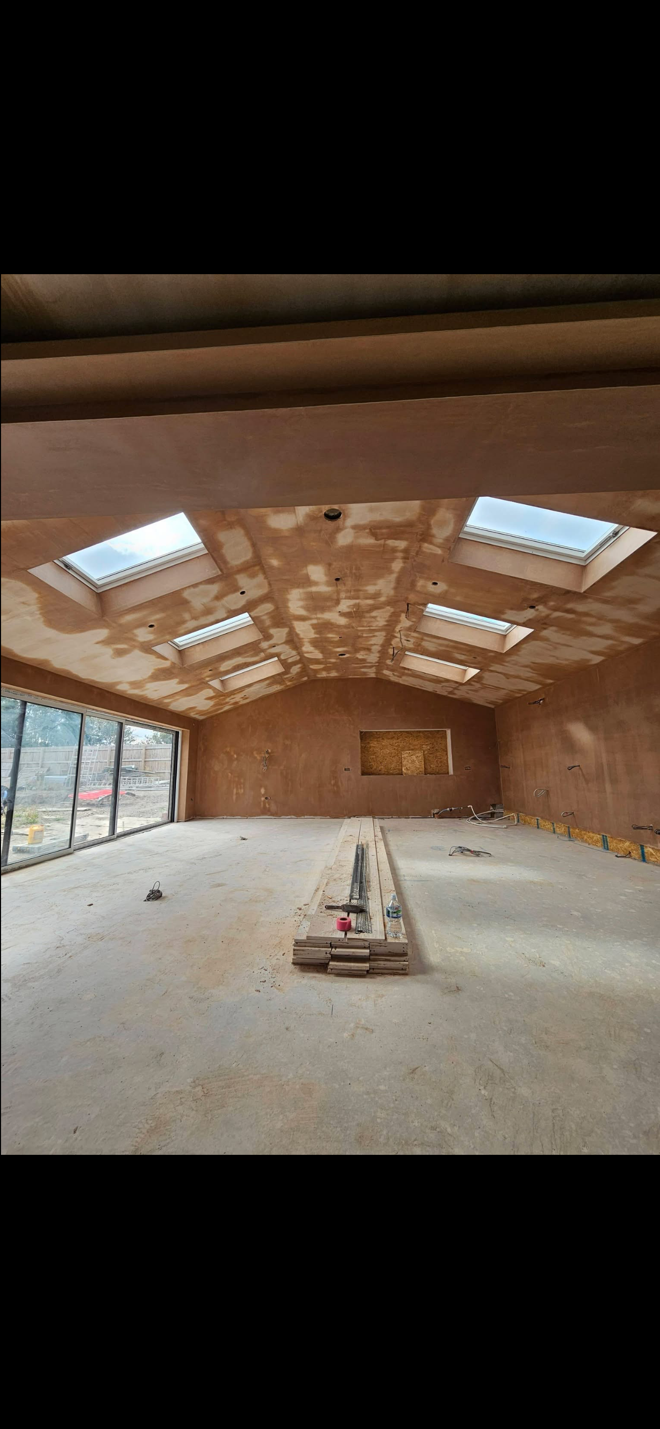 Open-plan plastered interior with clean ceiling lines